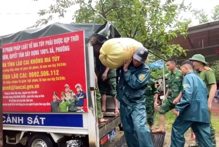 Lực lượng Công an xã Bát Xát hỗ trợ người dân di chuyển tài sản đến nơi an toàn. (Ảnh: CTV)