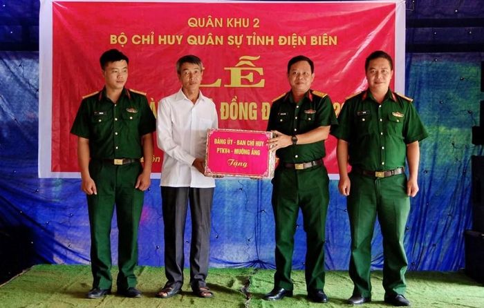 Đại diện Đảng ủy, Ban Chỉ huy Phòng thủ khu vực 4 - Mường Ảng trao quà tặng gia đình quân nhân Vừ A Hùng