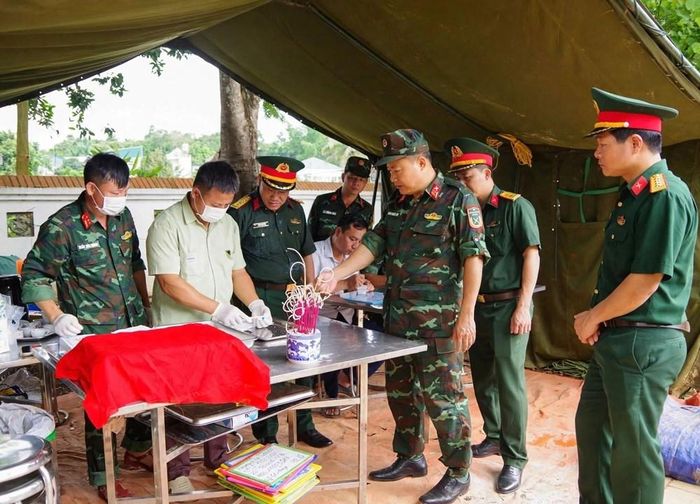 Đại tá Khổng Đình Tám, Chủ nhiệm Chính trị Quân khu 2 kiểm tra quy trình lấy mẫu sinh phẩm tại Nghĩa trang Liệt sĩ Độc Lập, xã Thanh Nưa