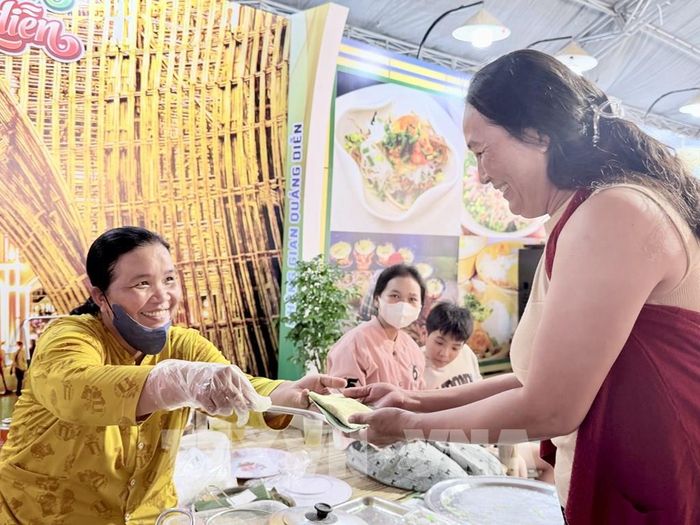Người dân thích thú nhận bánh rây miễn phí do các nghệ nhân Khmer chế biến. Ảnh: Thanh Sang- TTXVN