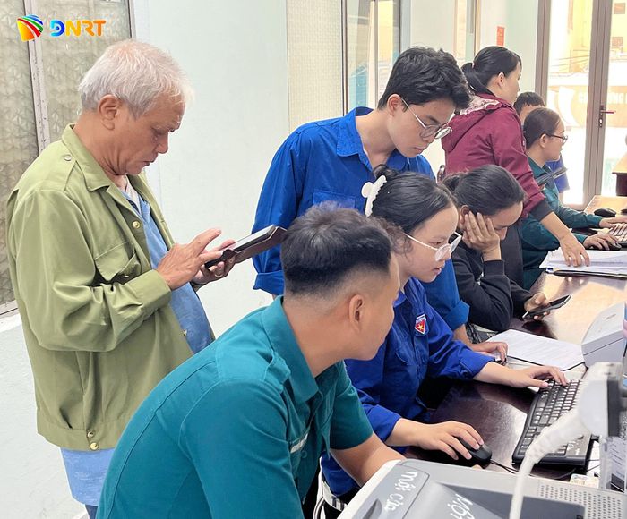 Sinh viên Tán Đại Phát (đứng) tham gia hỗ trợ người dân tại Trung tâm phục vụ hành chính công phường Liên Chiểu. Ảnh: LÂM VIÊN