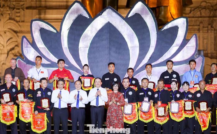 Ban Tổ chức trao kỷ niệm chương và cờ lưu niệm cho đại diện các đoàn võ thuật tham gia Liên hoan. Ảnh: Trương Định