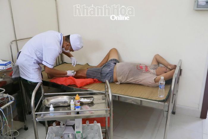 Bác sĩ quân y đảo Đá Tây tiến hành xử lý vết thương hở cho ngư dân.