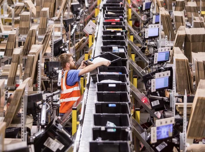 Một công nhân tại trung tâm phân phối của Amazon ở Ý. Ảnh : Giulio Napolitano / Bloomberg News