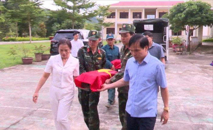 Ông Lê Viết Nam, Bí thư Đảng ủy, Chủ tịch HĐND xã Đăk Pék (bên phải) thực hiện nghi thức đưa hài cốt liệt sĩ được tìm thấy về Ban Chỉ huy quân sự xã. Ảnh: UBND xã Đăk Pék cung cấp