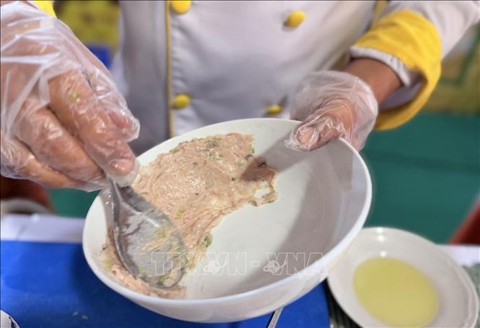 Đầu bếp quết chả mực giả nhuyễn vào thành tô trước khi chan nước dùng - Đây là công đoạn đặc trưng trong chế biến bún quậy Phú Quốc (An Giang).