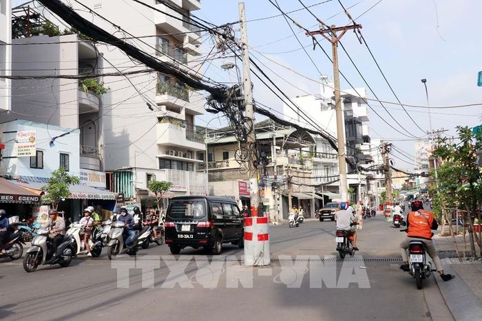 Tuyến đường Chu Văn An được mở rộng lên 23m với 4 làn xe nhưng hiện các trụ điện vẫn "án ngữ" giữ đường. Ảnh: Tiến Lực - TTXVN