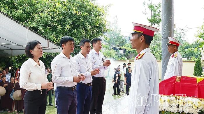 Các đại biểu và thân nhân gia đình thực hiện lễ truy điệu.