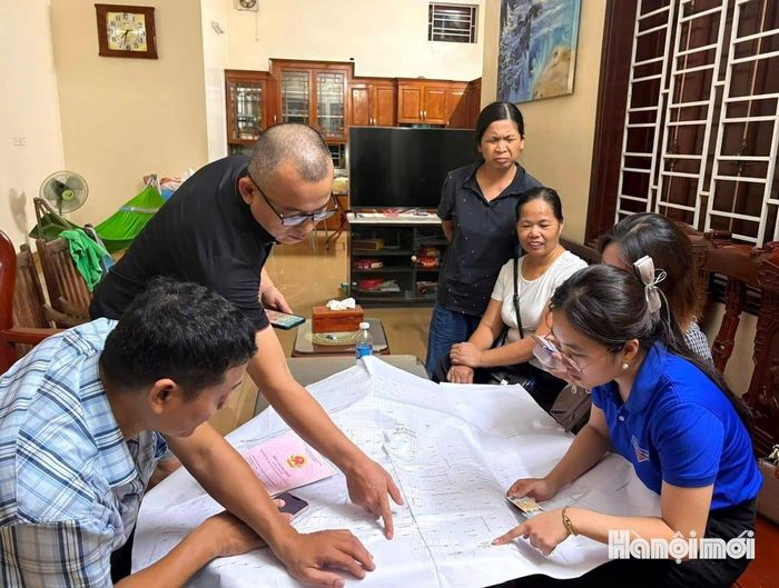 Tổ công tác làm việc buổi tối, hỗ trợ người dân cập nhật dữ liệu đất đai tại khu dân cư. Ảnh: Tuệ Lâm