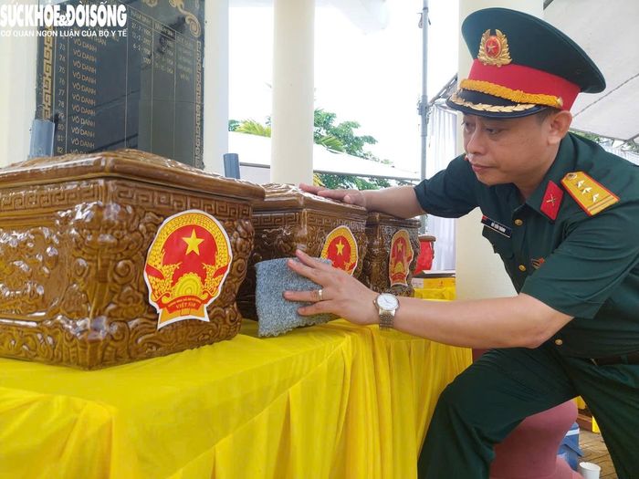 Thượng tá Đỗ Tiến Thành – Chỉ huy trưởng Ban CHQS xã Chí Minh kiểm tra những chiếc "áo mới" cho liệt sĩ sau khi khai quật. Ảnh: Đ.Tùy