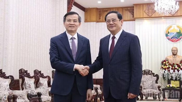 Đồng chí Đoàn Minh Huấn (bìa trái) chào xã giao Thủ tướng Chính phủ Lào Sonexay Siphandone. (Ảnh: DUY TOÀN)