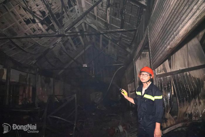 Trong không gian tối tăm của đám cháy vừa được dập tắt, mùi khói độc vẫn nồng nặc bốc lên cùng với sức nóng chưa kịp hạ nhiệt, các cán bộ, chiến sĩ vẫn bám trụ hiện trường. Ảnh: Công Nghĩa