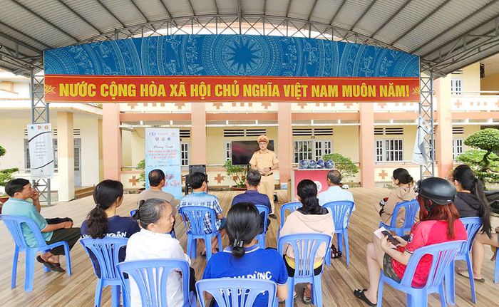 Cán bộ CSGT tuyên truyền pháp luật, hướng dẫn kiến thức an toàn giao thông cho người dân. Ảnh Lê Tiến
