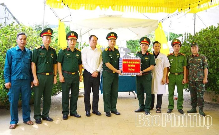 Đại tá Bùi Văn Mai - Phó Chỉ huy trưởng, Tham mưu trưởng Bộ CHQS tỉnh tặng quà các lực lượng đang thực hiện nhiệm vụ khai quật, lấy mẫu hài cốt liệt sĩ tại Nghĩa trang liệt sĩ xã Thanh Sơn.