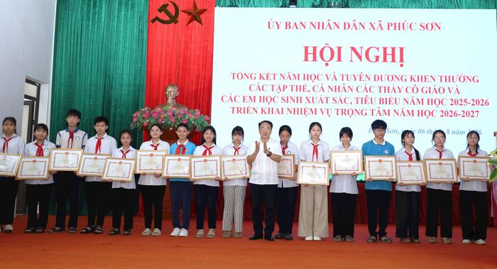 Bí thư Đảng ủy, Chủ tịch HĐND xã Phúc Sơn Phan Văn Sự khen thưởng học sinh giỏi xuất sắc, tiêu biểu năm học 2025-2026. Ảnh: Kim Nhuệ