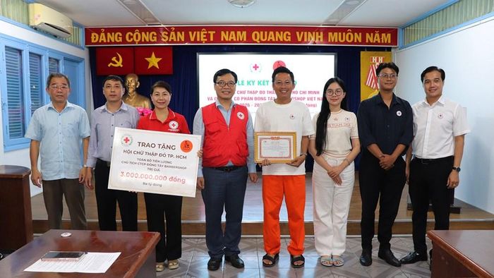 Chủ tịch Hội Chữ thập đỏ TP.HCM Nguyễn Minh Nhựt (thứ 4, từ trái qua) nhận bảng tượng trưng số tiền trao tặng và trao thư cám ơn đến ông Nguyễn Hoài Thanh