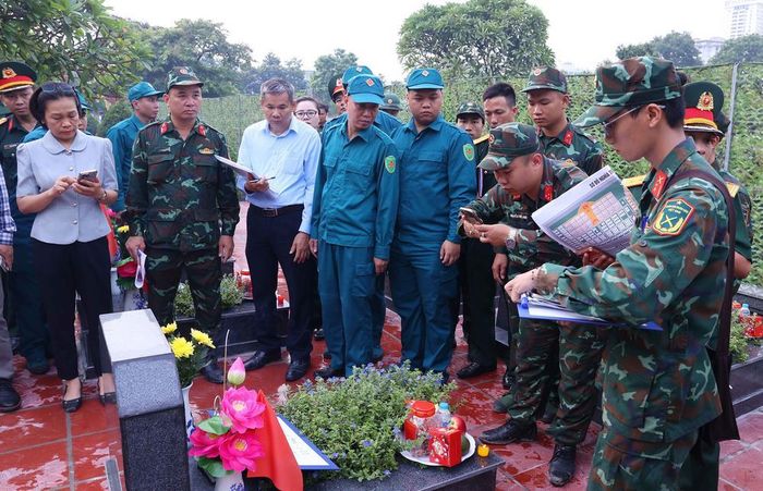 Việc mã hóa các phần mộ được thực hiện cẩn thận trước khi tiến hành khai quật lấy mẫu sinh phẩm tại Nghĩa trang Mai Dịch (phường Phú Diễn). Ảnh: Văn Điệp – TTXVN