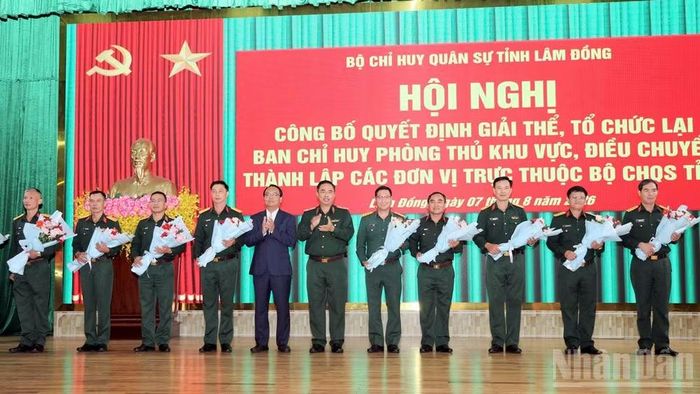 Thiếu tướng Lê Xuân Bình và Phó Bí thư thường trực Tỉnh ủy Lâm Đồng Đặng Hồng Sỹ chúc mừng các cá nhân tại hội nghị. (Ảnh: BẢO ĐÔNG)