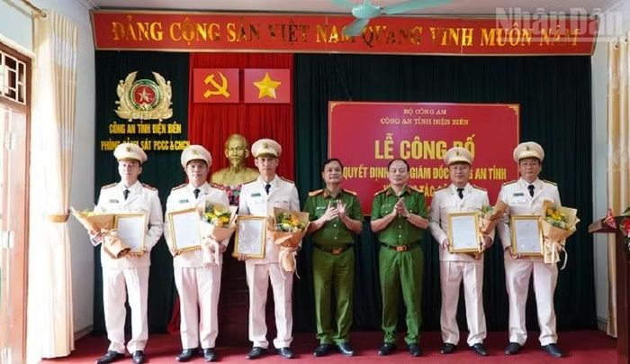 Đại tá Vũ Tiến Dũng (thứ 3 từ phải sang) trao quyết định cho các cán bộ được Giám đốc Công an tỉnh Điện Biên điều động, giao nhiệm vụ tại Đội Chữa cháy và Cứu nạn, cứu hộ khu vực Sam Mứn.