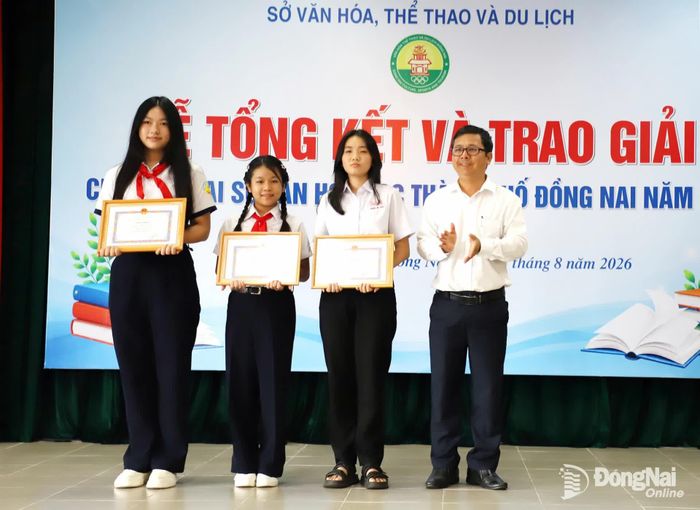 Giám đốc Thư viện Đồng Nai Hồ Tiến Duật trao giải nhất cho các thí sinh. Ảnh: My Ny