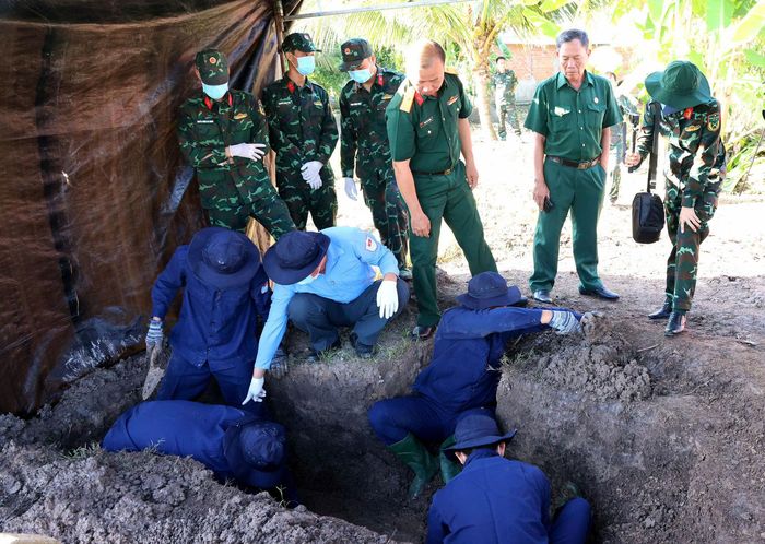 Đội tìm kiếm quy tập hài cốt liệt sĩ lâm thời phối hợp với Đội K90 cất bốc hài cốt liệt sĩ Nguyễn Thị Út (Ảnh: P.T).