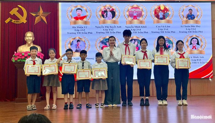 Trưởng Ban Xây dựng Đảng phường Lĩnh Nam Lương Thị Thủy trao khen thưởng cho các em học sinh có thành tích cao trong học tập, năm học 2025-2026. Ảnh: PV