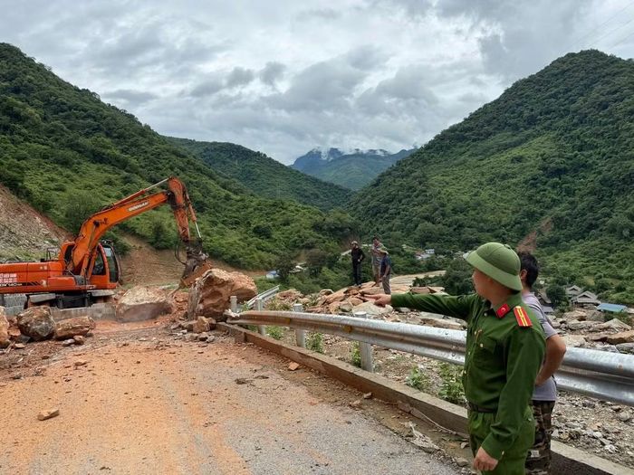 Máy móc được huy động dọn dẹp đất đá, khơi thông đường cho người dân.
