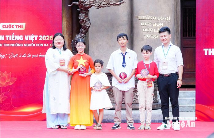 Đại diện Ban Tổ chức vinh danh thí sinh có thành tích xuất sắc của Cuộc thi Hùng biện tiếng Việt 2026. Ảnh: TL