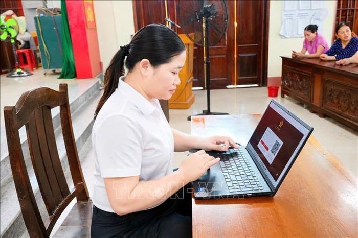 Chị Hoàng Thị Ngọc, Trưởng thôn Phú Lộc (Thanh Hóa) thường xuyên cập nhập công nghệ thông tin, ứng dụng số để điều hành các hoạt động của thôn mới sau sáp nhập. Ảnh: Khiếu Tư/TTXVN