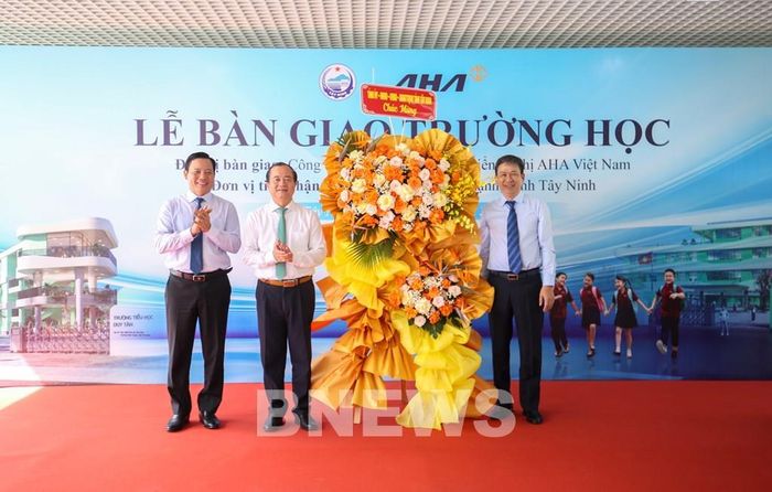 Đại diện lãnh đạo UBND tỉnh Tây Ninh tặng hoa chúc mừng các đơn vị tại Lễ bàn giao hai công trình trường học. Ảnh: Giang Phương - TTXVN