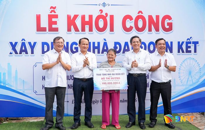 Phó Bí thư Thành ủy, Chủ tịch Ủy ban MTTQ Việt Nam thành phố Nguyễn Đình Vĩnh (thứ 2, trái sang) trao hỗ trợ kinh phí xây dựng nhà Đại đoàn kết cho bà Đỗ Thị Hương. Ảnh: HỒ QUÂN