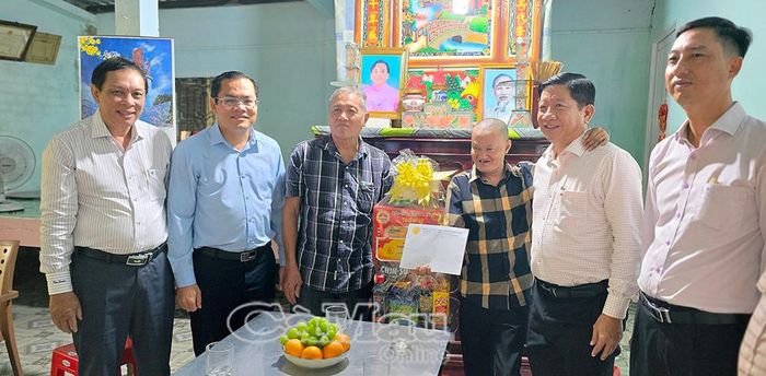 Phó Chủ tịch UBND tỉnh Ngô Vũ Thăng (thứ hai từ trái sang) và Phó Chủ tịch Hội Nạn nhân chất độc da cam/dioxin tỉnh Nguyễn Xuân Tình (bìa trái) tặng quà cho nạn nhân da cam trên địa bàn xã Đầm Dơi.
