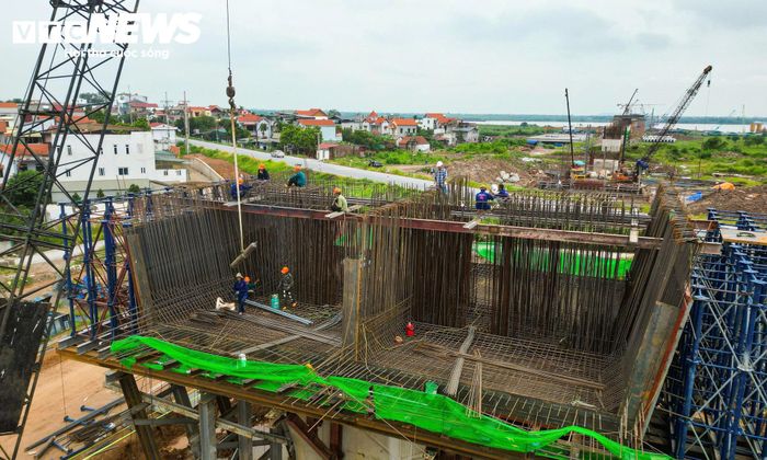 Công nhân được huy động thi công trên các thân trụ cầu đã hoàn thành phần bệ. Máy móc, thiết bị và phương tiện phục vụ xây dựng được bố trí tại nhiều vị trí để duy trì các mũi thi công.