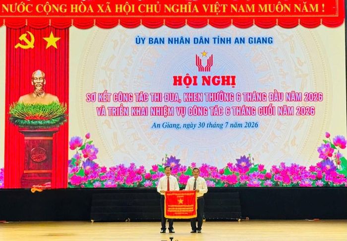 Phó Chủ tịch UBND tỉnh An Giang Lê Văn Phước trao Cờ thi đua của Chính phủ cho Phó Chủ tịch UBND xã Mỹ Hòa Hưng Nguyễn Trung Nam