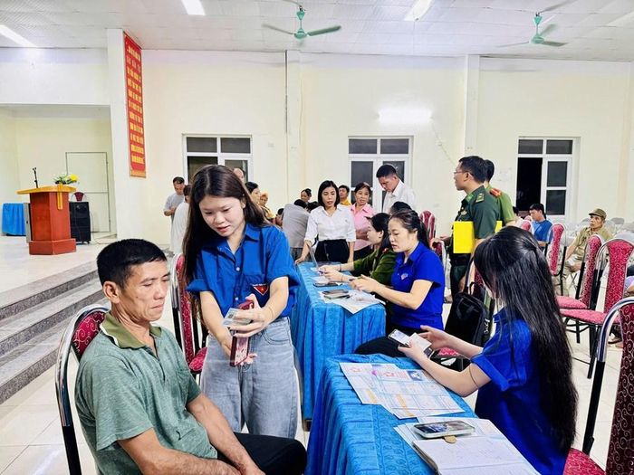Các thành viên Tổ công nghệ số cộng đồng hướng dẫn người dân thực hiện dịch vụ công trực tuyến