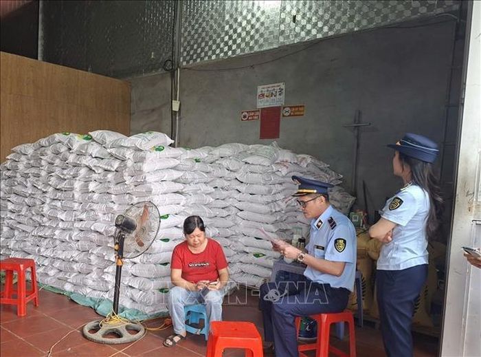 Chi cục quản lí thị trường phát hiện hộ kinh doanh Quân Lan đang đóng gạo vào bao bì Gạo Séng Cù Mường Khương. Ảnh: TTXVN phát