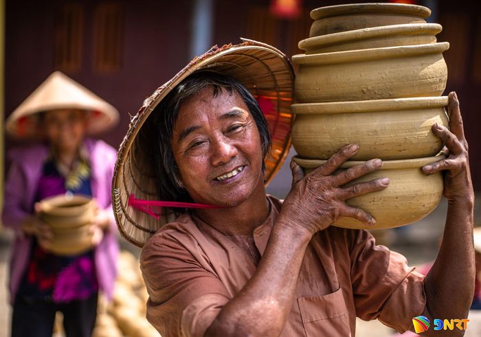 Người thợ làng gốm Thanh Hà nâng niu từng sản phẩm vừa hoàn thiện - thành quả của đôi tay và kinh nghiệm tích lũy qua nhiều thế hệ.