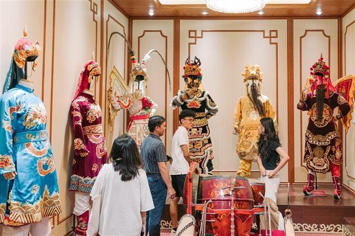 Khán giả tham quan không gian giới thiệu phục trang, đạo cụ và tạo hình nhân vật Tuồng trước giờ diễn, từ đó có thêm cơ hội tiếp cận những lớp giá trị nằm phía sau một tác phẩm sân khấu truyền thống. Ảnh: Phạm Tuấn Anh - TTXVN