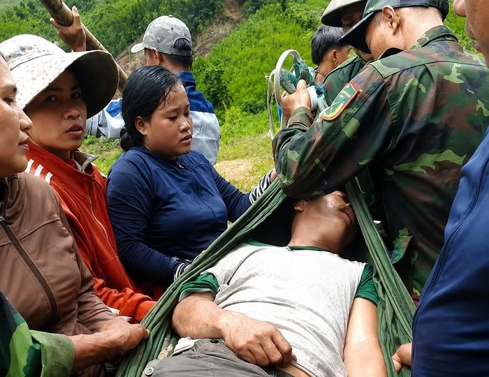 Lực lượng chức năng và người dân đưa nạn nhân đi cấp cứu.