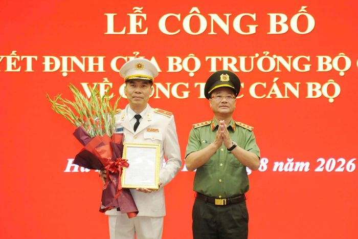 Thượng tướng Phạm Thế Tùng trao quyết định, tặng hoa Thiếu tướng Cao Minh Huyền, tân Cục trưởng Cục Quản lý xuất nhập cảnh. Ảnh: A08