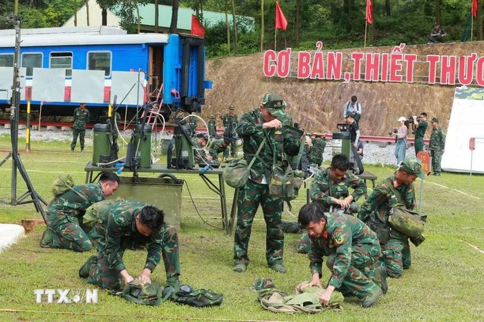 Lực lượng hóa học thu dọn quân trang sau khi thực hiện bài thi tẩy trùng hiện trường bị nhiễm chất độc hại. (Ảnh: Trọng Đức/TTXVN)