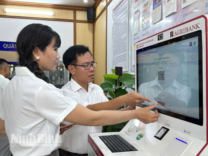 Chuyên viên Trung tâm Phục vụ hành chính công xã Giao Phúc hướng dẫn người dân thực hiện các thao tác trên Hệ thống Kiosk thông minh.