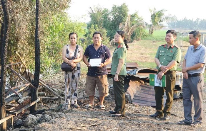 Đại tá Võ Thị Hoài Ngọc, Phó Giám đốc Công an tỉnh Đồng Tháp trao tiền hỗ trợ anh Huỳnh Văn Chưởng, Tổ phó Tổ bảo vệ ANTT ấp 5A, xã Trường Xuân.