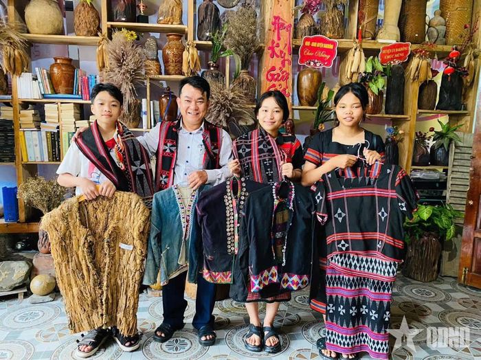 Anh Hồ Phương (thứ hai, từ bên trái sang) cùng các em học sinh giới thiệu một số trang phục truyền thống của dân tộc Vân Kiều, Pa Kô. 