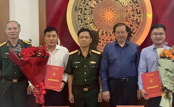 Thiếu tướng Nguyễn Chí Công và Thứ trưởng Bộ VHTTDL Tạ Quang Đông trao Quyết định cho đồng chí Cao Lê Tuấn Anh và Nguyễn Hữu Ngọc