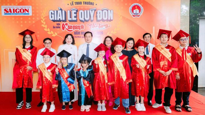 Đồng chí Lê Quốc Phong, Ủy viên Trung ương Đảng, Phó Bí thư Thường trực Thành ủy TPHCM và đại diện Ban Biên tập Báo Sài Gòn Giải Phóng chụp ảnh cùng các học sinh đoạt Giải Lê Quý Đôn năm học 2025-2026. Ảnh: QUỐC KHÁNH