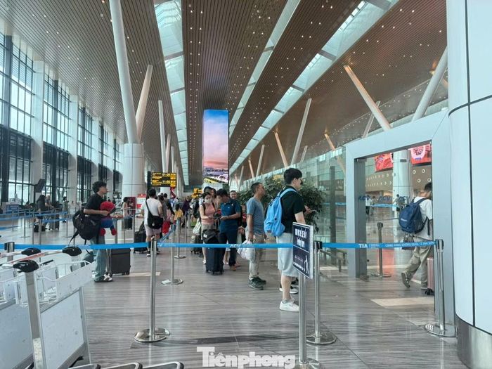 Hành khách xếp hàng làm thủ tục qua cửa an ninh.