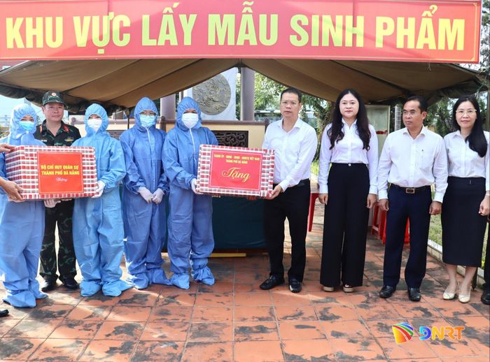 Chủ tịch UBND thành phố Nguyễn Mạnh Hùng (thứ 4, từ phải qua) tặng quà lực lượng làm nhiệm vụ tại Nghĩa trang liệt sĩ Hòa Châu. Ảnh: QUỐC TUẤN