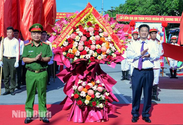 Đồng chí Trần Anh Dũng, Ủy viên Ban Thường vụ Tỉnh ủy, Phó Chủ tịch UBND tỉnh, Trưởng Ban Chỉ đạo PCCC và CNCH tỉnh tặng hoa chúc mừng Hội thi.