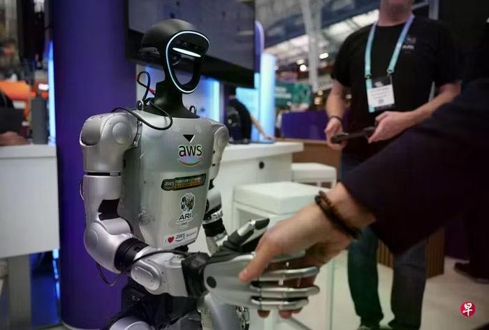 Robot Unitree bắt tay và giao lưu với khách tham quan. Ảnh: Zaobao.